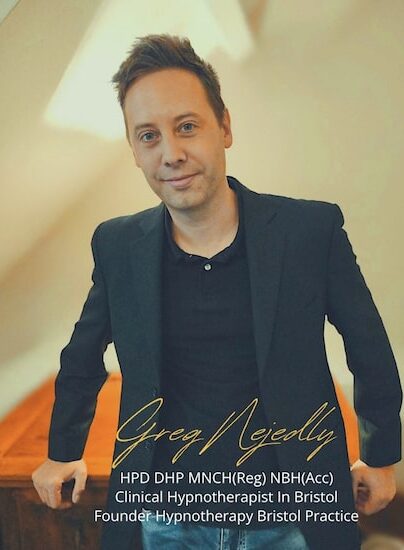 Greg Nejedly profile pic Profile pic of Greg Nejedly leaning against a desk, smartly dressed.